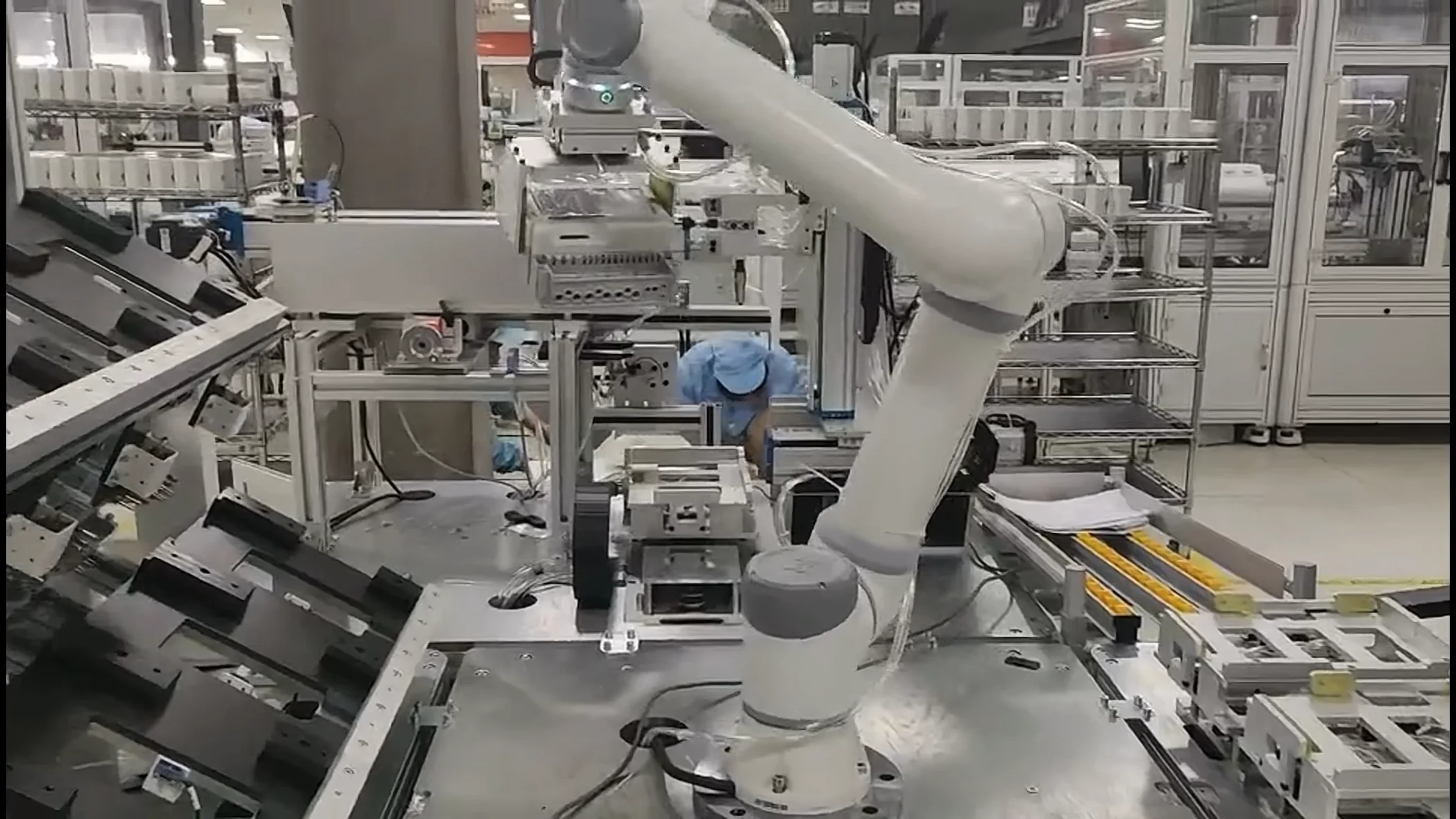 Medical and lab scene: collaborative robotic arm aliquoting and transferring samples on a bench.