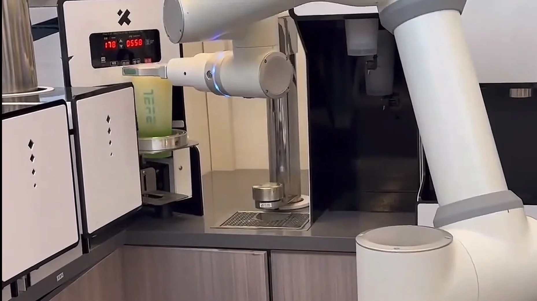 Retail and service scene: collaborative robotic arm in a compact front-house service workflow.